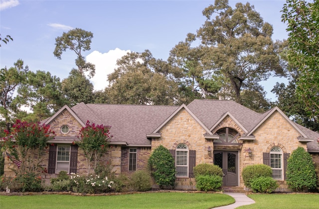 33922 High Point Dr, Magnolia, TX 77355 - view of front of home with stone siding, roof with shingles, a front yard, and brick siding