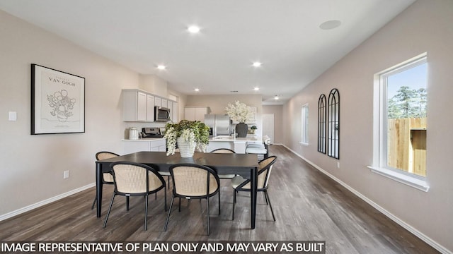 dining space with baseboards, dark wood finished floors, and recessed lighting