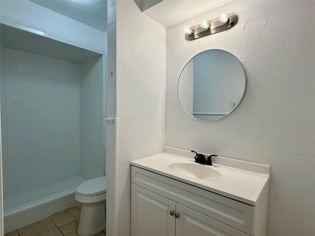 full bath with a shower stall, tile patterned floors, vanity, and toilet