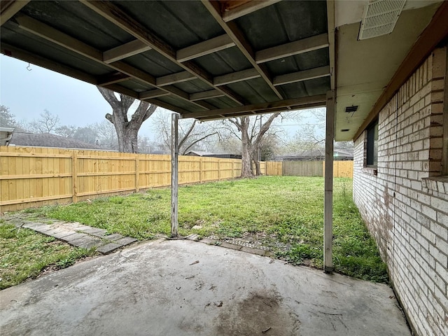 view of yard featuring a fenced backyard, visible vents, and a patio area