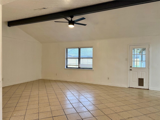 empty room featuring a wealth of natural light, a ceiling fan, vaulted ceiling with beams, and light tile patterned floors