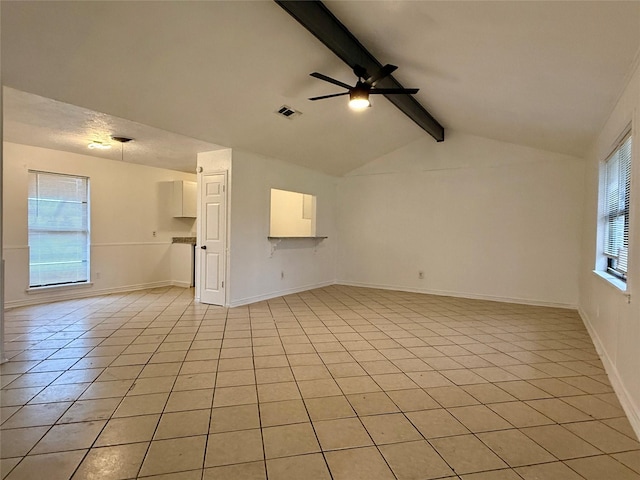 unfurnished living room featuring light tile patterned flooring, vaulted ceiling with beams, visible vents, baseboards, and a ceiling fan