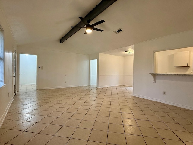 spare room with lofted ceiling with beams, baseboards, visible vents, ceiling fan, and light tile patterned floors