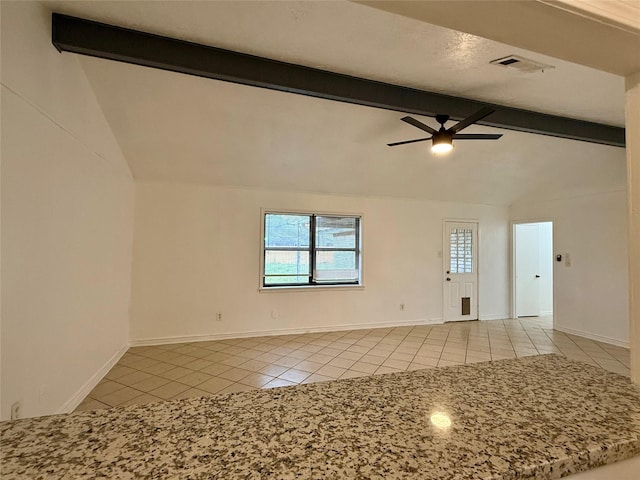 spare room with light tile patterned flooring, a ceiling fan, baseboards, and lofted ceiling with beams