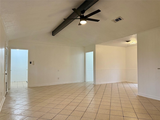 unfurnished room featuring visible vents, a ceiling fan, vaulted ceiling with beams, and light tile patterned floors