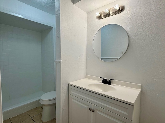 full bathroom with toilet, vanity, a stall shower, and tile patterned floors