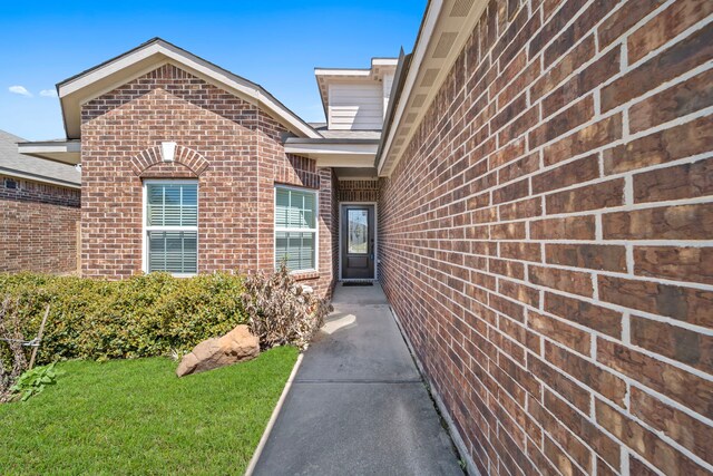 7623 Square Garden Ln, Conroe, TX 77304 - entrance to property with brick siding and a yard