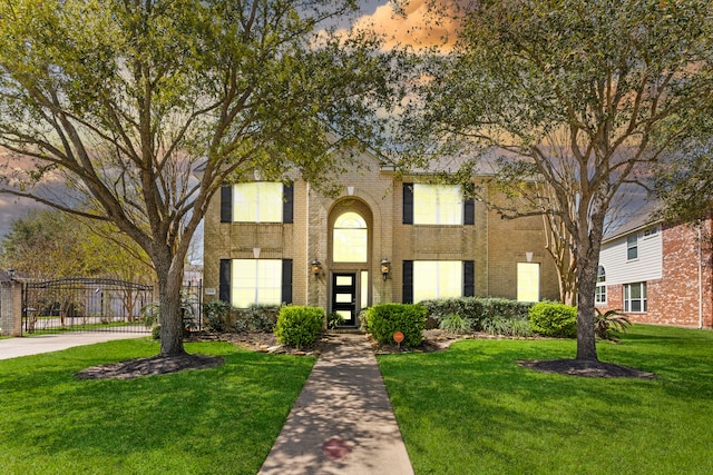 1906 Blue Water Bay Dr, Katy, TX 77494 - view of front facade with brick siding, a gate, and a yard