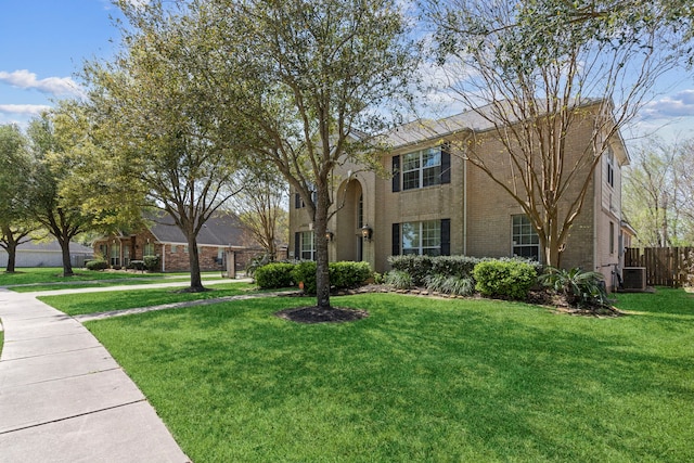 1906 Blue Water Bay Dr, Katy, TX 77494 - view of front facade featuring brick siding, central AC unit, a front lawn, and fence