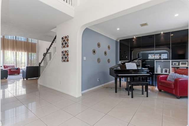 1906 Blue Water Bay Dr, Katy, TX 77494 - interior space featuring crown molding, baseboards, stairs, arched walkways, and light tile patterned floors