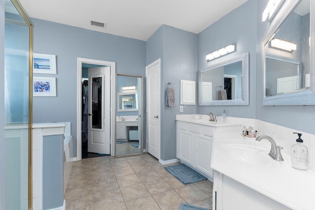 1906 Blue Water Bay Dr, Katy, TX 77494 - bathroom featuring a sink, a spacious closet, tile patterned flooring, visible vents, and double vanity