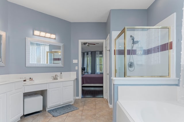 1906 Blue Water Bay Dr, Katy, TX 77494 - ensuite bathroom featuring a shower stall, ceiling fan, vanity, a garden tub, and tile patterned flooring