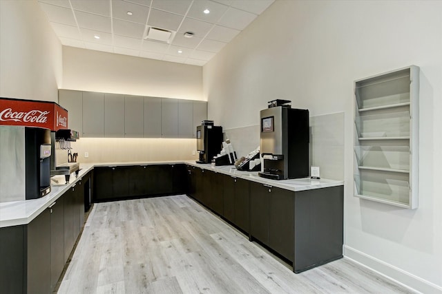 3333 Allen Pkwy Unit 701, Houston, TX 77019 - kitchen with light wood-style flooring, a paneled ceiling, light countertops, modern cabinets, and baseboards