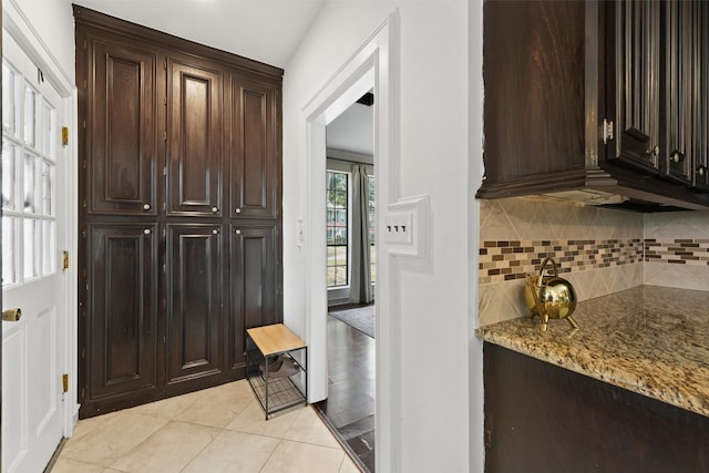 interior space with light tile patterned floors and backsplash