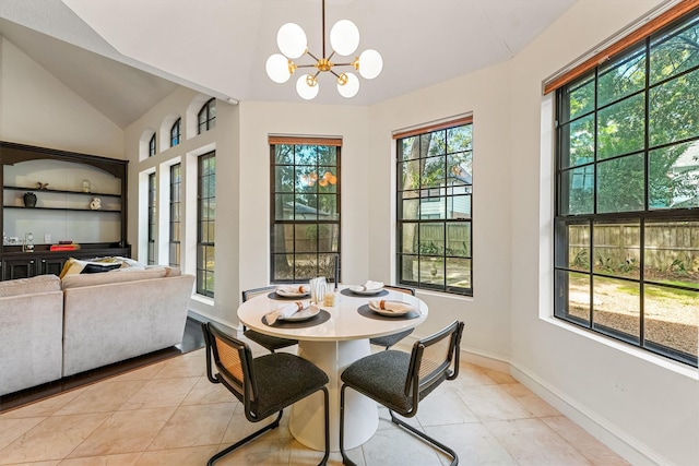 dining room featuring baseboards, light tile patterned floors, a notable chandelier, and lofted ceiling