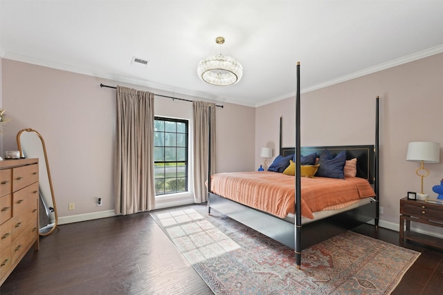 bedroom featuring a notable chandelier, baseboards, crown molding, and wood finished floors
