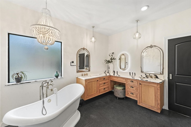 full bathroom with an inviting chandelier, a freestanding tub, a sink, and double vanity