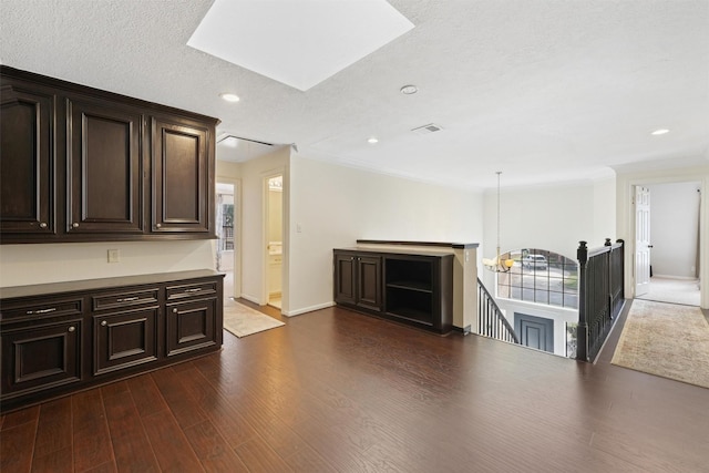 interior space with dark brown cabinetry, baseboards, recessed lighting, visible vents, and dark wood finished floors