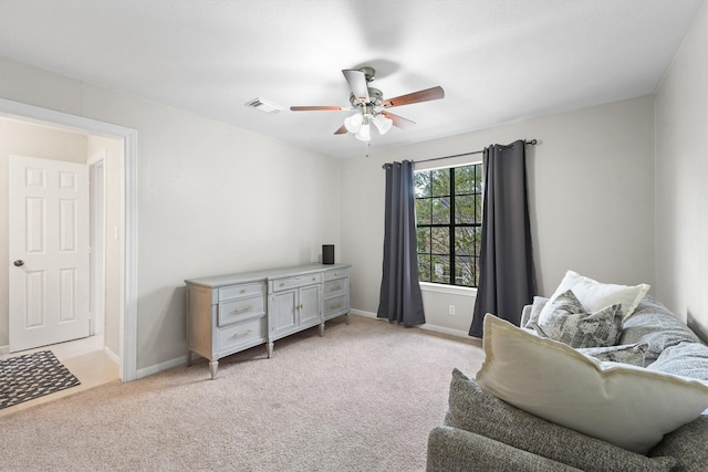 sitting room featuring light carpet, visible vents, baseboards, and ceiling fan