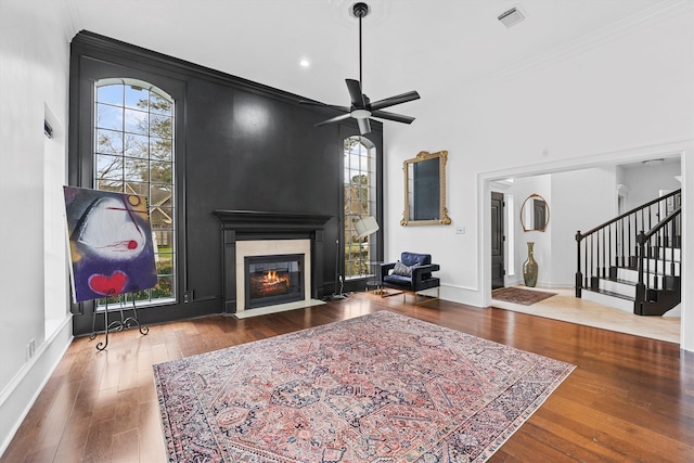 living room featuring a wealth of natural light, a fireplace with flush hearth, and hardwood / wood-style flooring