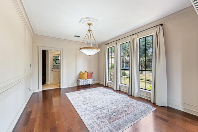 dining space featuring ornamental molding, baseboards, visible vents, and dark wood-style floors
