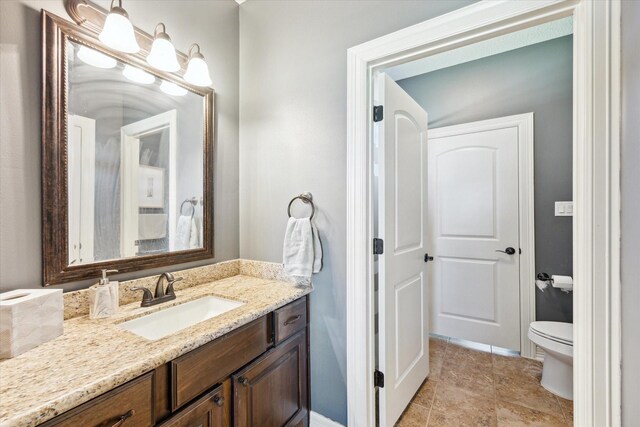 2688 Settlers Way Dr, Sealy, TX 77474 - bathroom featuring toilet, vanity, tile patterned flooring, and baseboards