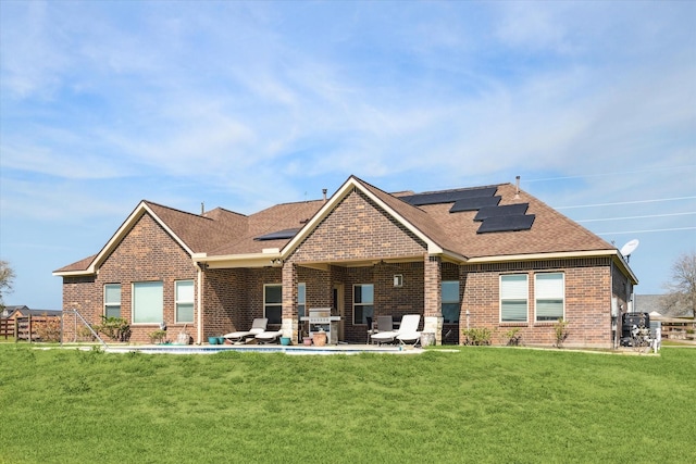 2688 Settlers Way Dr, Sealy, TX 77474 - back of property featuring brick siding, solar panels, and a patio area