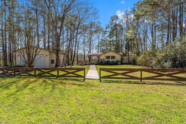 view of yard featuring an outdoor structure and fence
