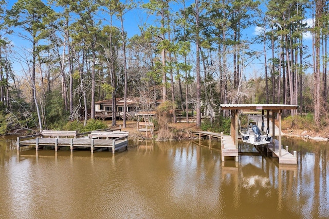 dock area with a water view and a view of trees