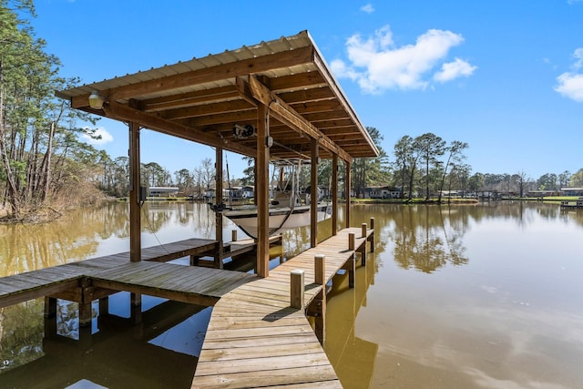 view of dock with boat lift and a water view