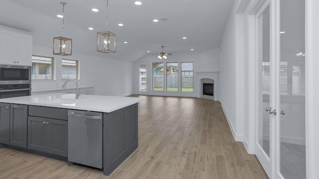 19415 Sorrel Stallion Trl, Tomball, TX 77377 - kitchen featuring appliances with stainless steel finishes, gray cabinets, ceiling fan, light countertops, and recessed lighting