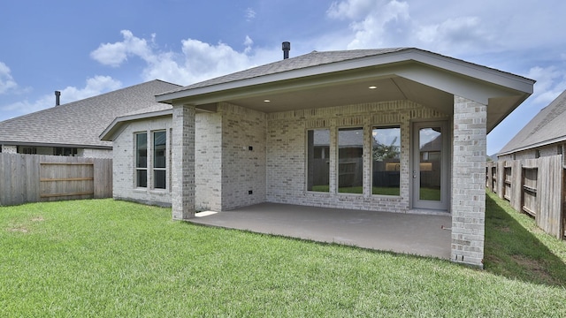 19415 Sorrel Stallion Trl, Tomball, TX 77377 - back of house featuring brick siding, a patio area, and a shingled roof