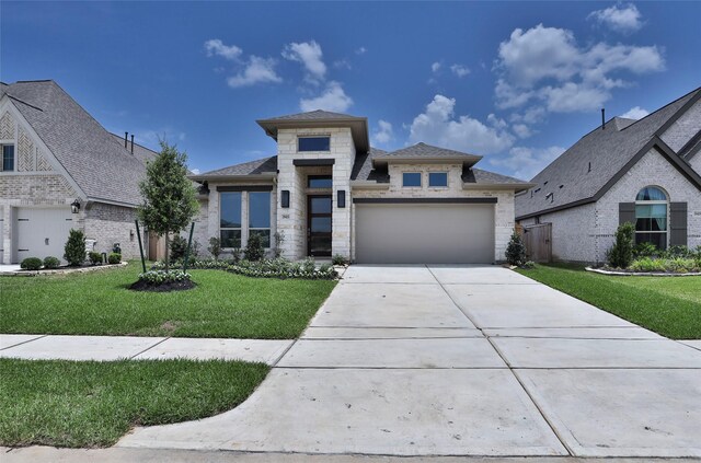 19415 Sorrel Stallion Trl, Tomball, TX 77377 - prairie-style house featuring concrete driveway, an attached garage, a front lawn, brick siding, and a shingled roof