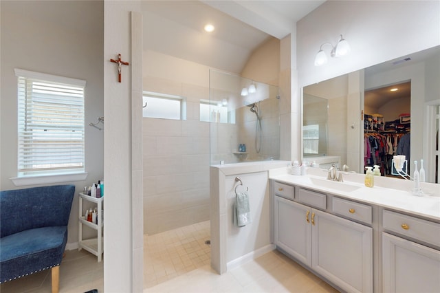 21586 Jordan Pond Rdg, Porter, TX 77365 - bathroom with lofted ceiling, a walk in shower, vanity, a walk in closet, and tile patterned flooring