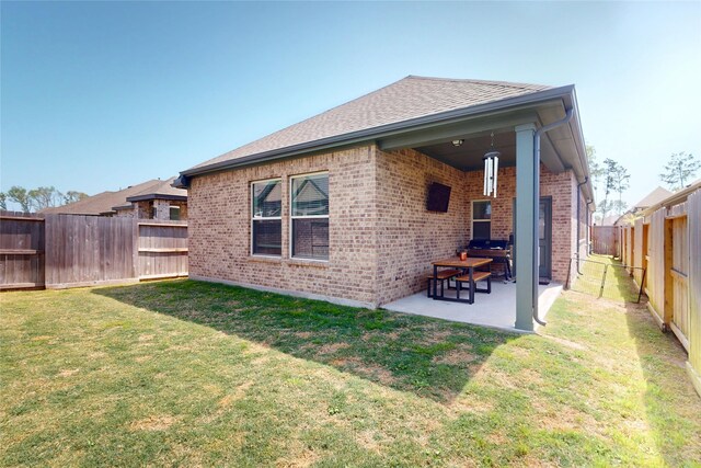 21586 Jordan Pond Rdg, Porter, TX 77365 - rear view of house with brick siding, a patio, and a shingled roof
