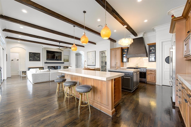 3702 Blue Bonnet, Houston, TX 77025 - kitchen featuring arched walkways, a spacious island, premium range hood, high quality appliances, and beamed ceiling