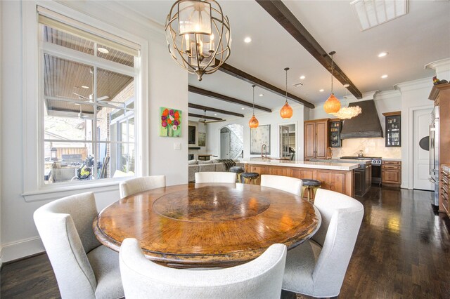 3702 Blue Bonnet, Houston, TX 77025 - dining area featuring a chandelier, beam ceiling, dark wood-style flooring, ceiling fan, and arched walkways