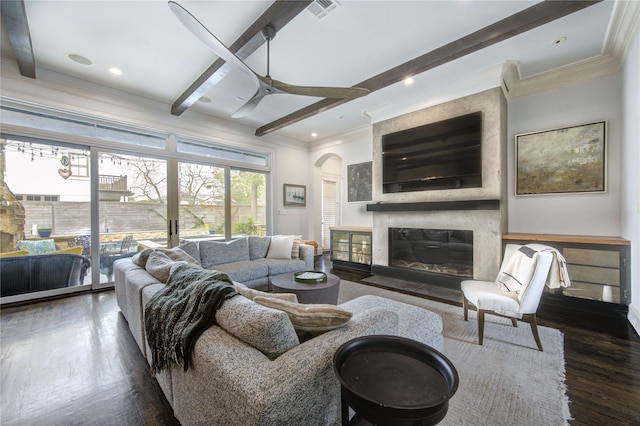 3702 Blue Bonnet, Houston, TX 77025 - living room with a large fireplace, beamed ceiling, arched walkways, crown molding, and dark wood-style flooring