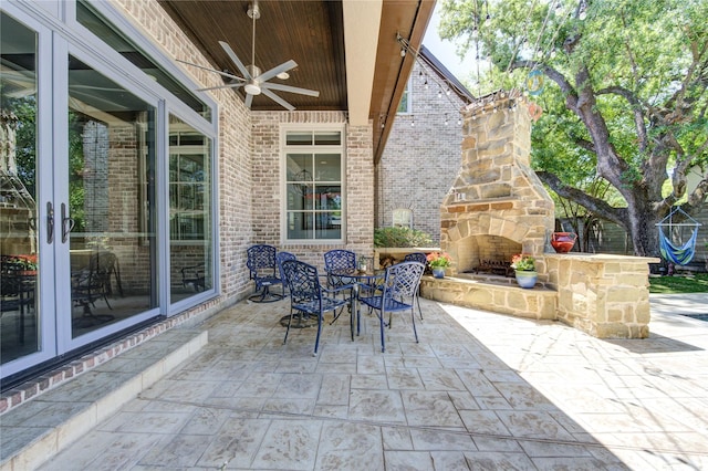 3702 Blue Bonnet, Houston, TX 77025 - view of patio / terrace featuring an outdoor stone fireplace, french doors, a ceiling fan, and outdoor dining space