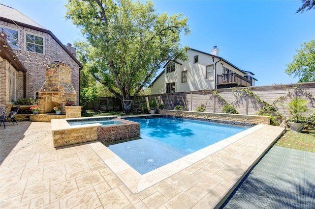 3702 Blue Bonnet, Houston, TX 77025 - view of swimming pool with a fenced backyard, a patio, an outdoor stone fireplace, and a pool with connected hot tub