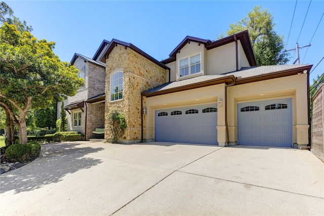 3702 Blue Bonnet, Houston, TX 77025 - view of front of property with driveway, an attached garage, stucco siding, and stone siding