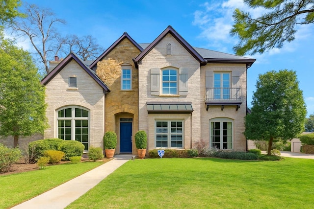 3702 Blue Bonnet, Houston, TX 77025 - french country inspired facade with a front yard, stone siding, and a balcony
