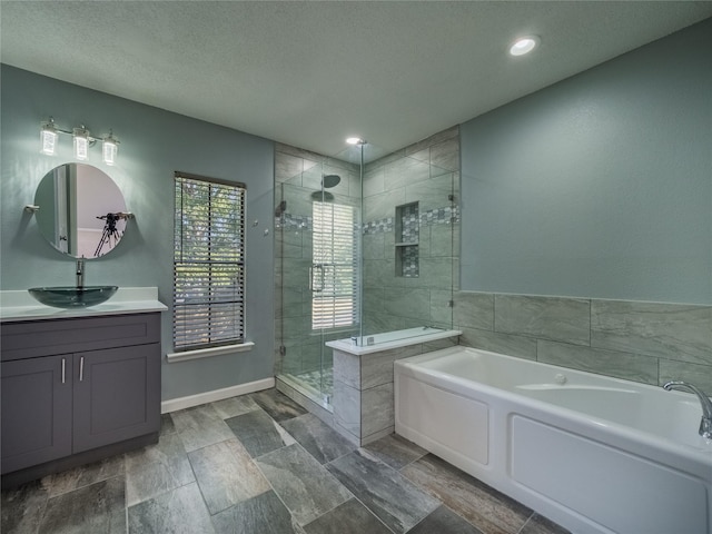 full bathroom with recessed lighting, a garden tub, vanity, a textured ceiling, and a stall shower