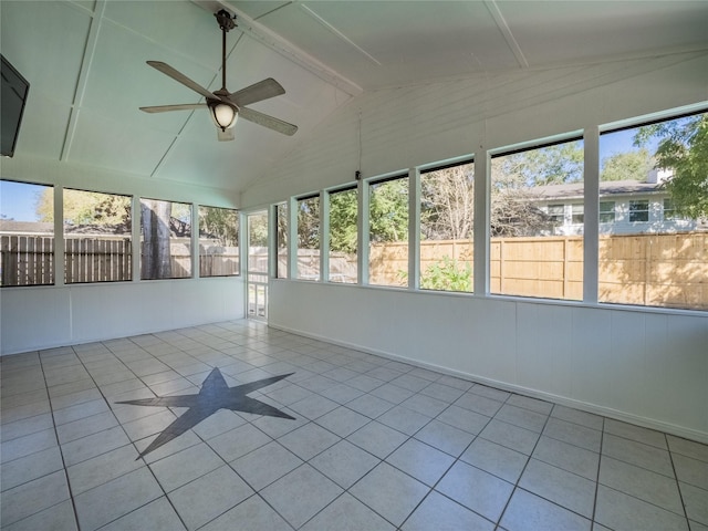 unfurnished sunroom featuring tile patterned floors, lofted ceiling with beams, and ceiling fan