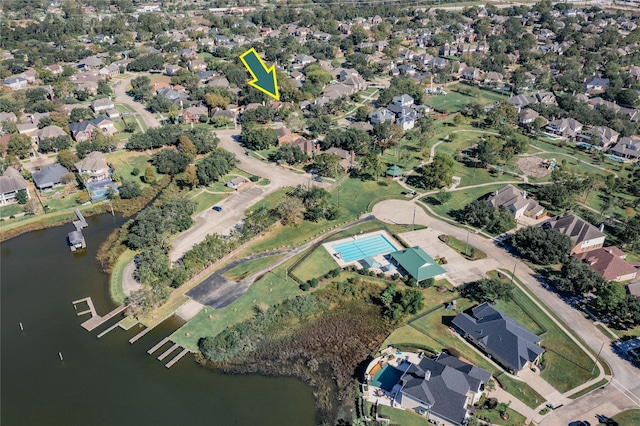 drone / aerial view with a residential view and a water view