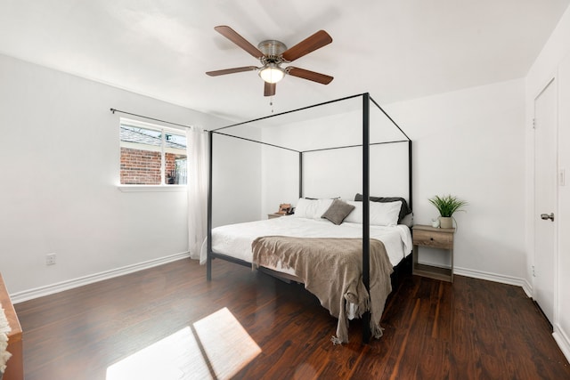 bedroom featuring baseboards, wood finished floors, and a ceiling fan