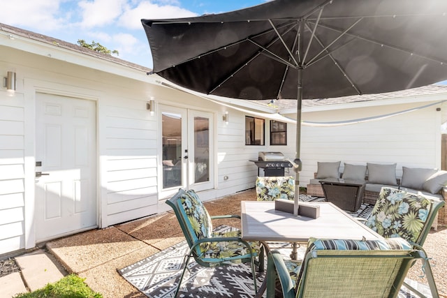 view of patio with an outdoor living space, area for grilling, and french doors