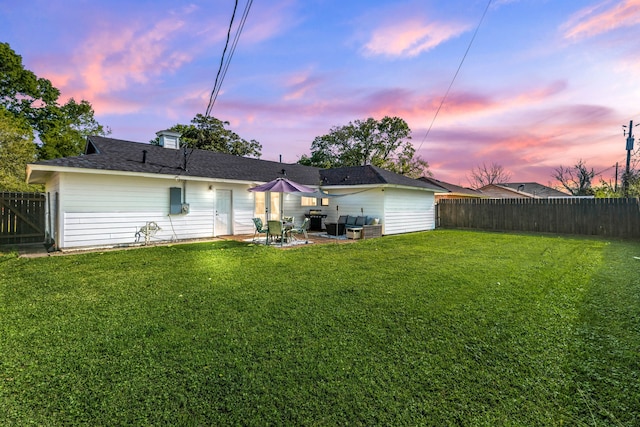 back of property featuring a lawn, a fenced backyard, and a patio area