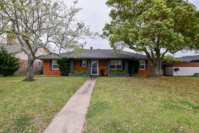 5521 Rosewood Dr, Galveston, TX 77551 - single story home featuring brick siding and a front lawn