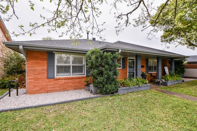 5521 Rosewood Dr, Galveston, TX 77551 - view of front of house featuring a front lawn and brick siding